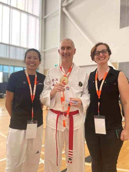 Greg and his Gold Cost Open Gold Medal with Master Shirly and Instructor Nicole