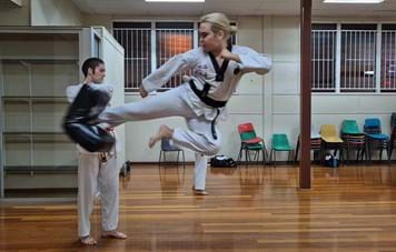Taekwondo Instructor Nathan doing flying side kick
