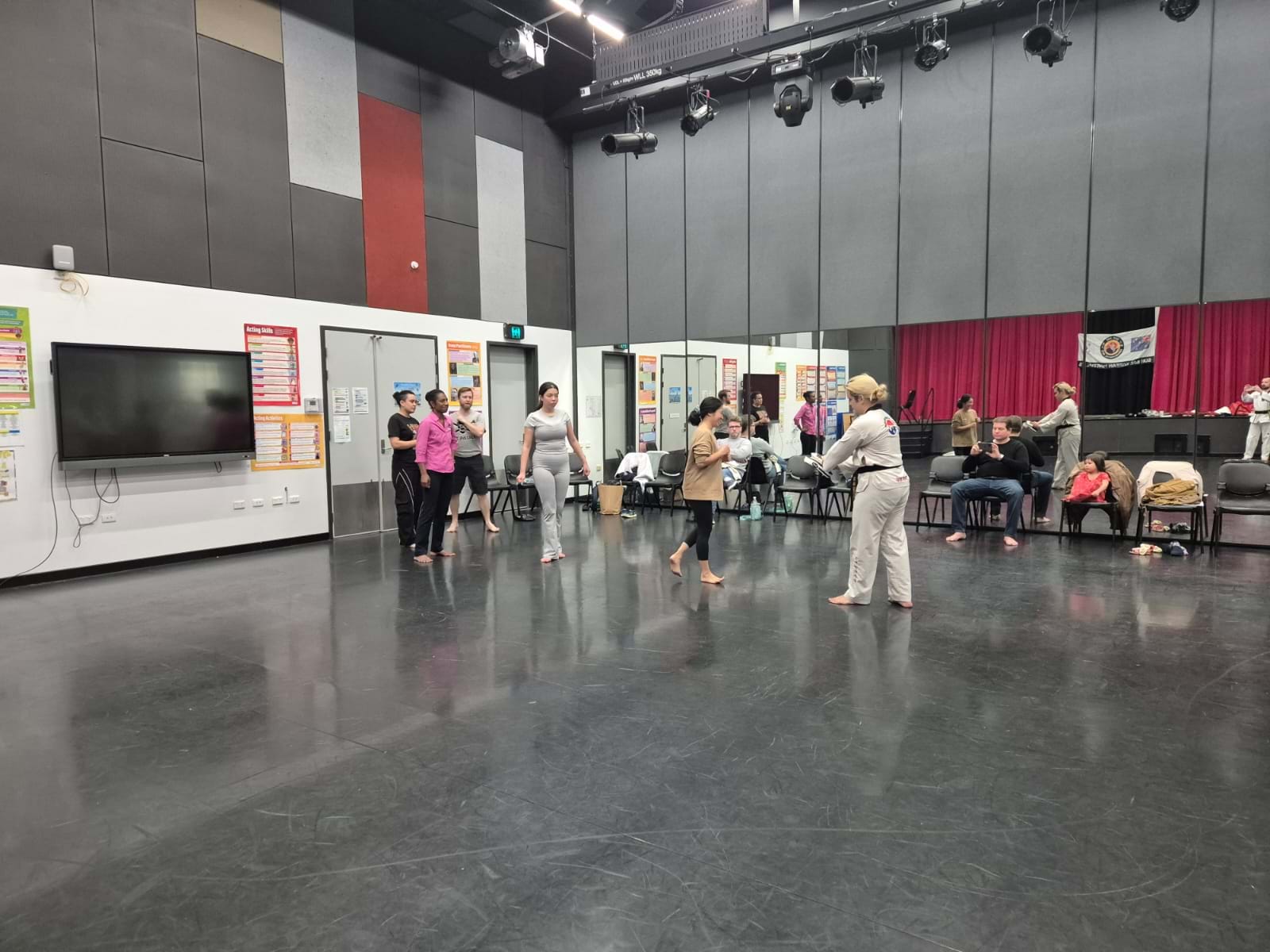 Adults Learn Front Kick in Formation at Taekwondo Dojang Opening