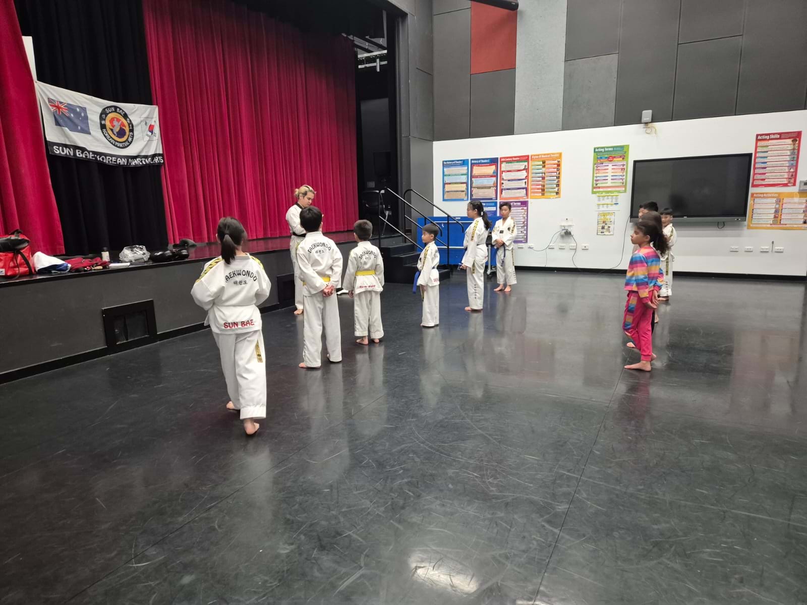 Kids Listen Attentively to Instructor at Taekwondo Dojang Opening