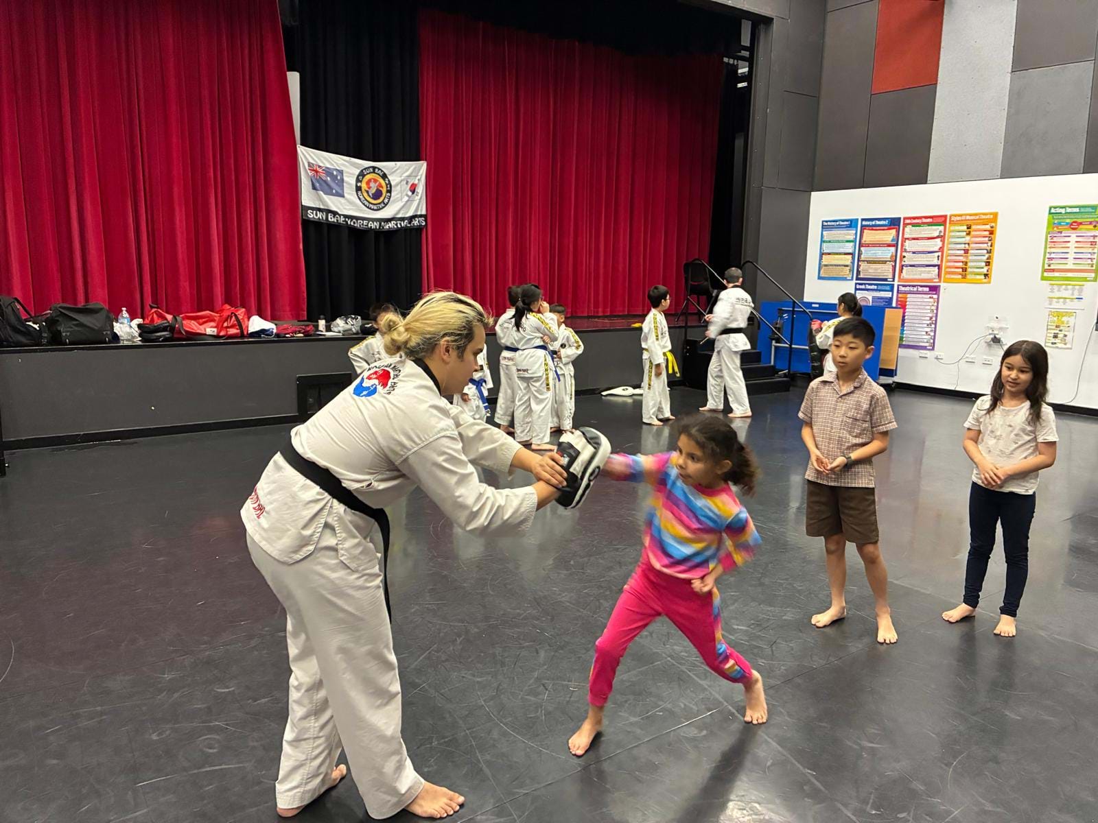 Children Line Up to Practise Punching at Taekwondo Dojang Launch
