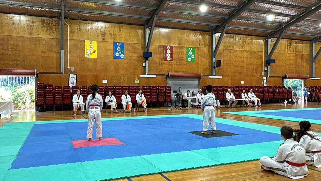 Taekwondo action - Sun Bae Korean Martial Art - Taekwondo Championship - Patterns, High Kick, Power Breaking, Roof Tiles, Kukkiwon, WT - World Taekwondo, Australia, Brisbane, Centres locations at Kenmore, Newmarket, The Gap, Middle Park, Mt Gravatt, Toowoomba, Grandmaster Bradley Tatnell. competition, white belt, yellow belt, blue belt, red belt, black belt, children, adults, male, female.