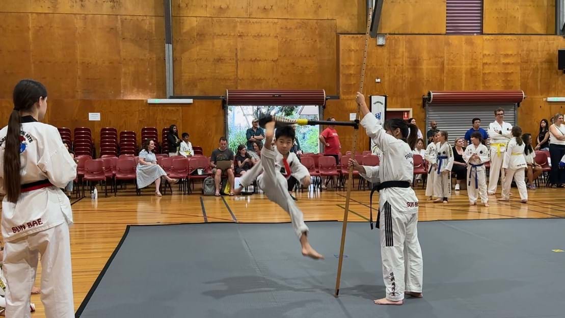 Taekwondo action - Sun Bae Korean Martial Art - Taekwondo Championship - Patterns, High Kick, Power Breaking, Roof Tiles, Kukkiwon, WT - World Taekwondo, Australia, Brisbane, Centres locations at Kenmore, Newmarket, The Gap, Middle Park, Mt Gravatt, Toowoomba, Grandmaster Bradley Tatnell. competition, white belt, yellow belt, blue belt, red belt, black belt, children, adults, male, female.