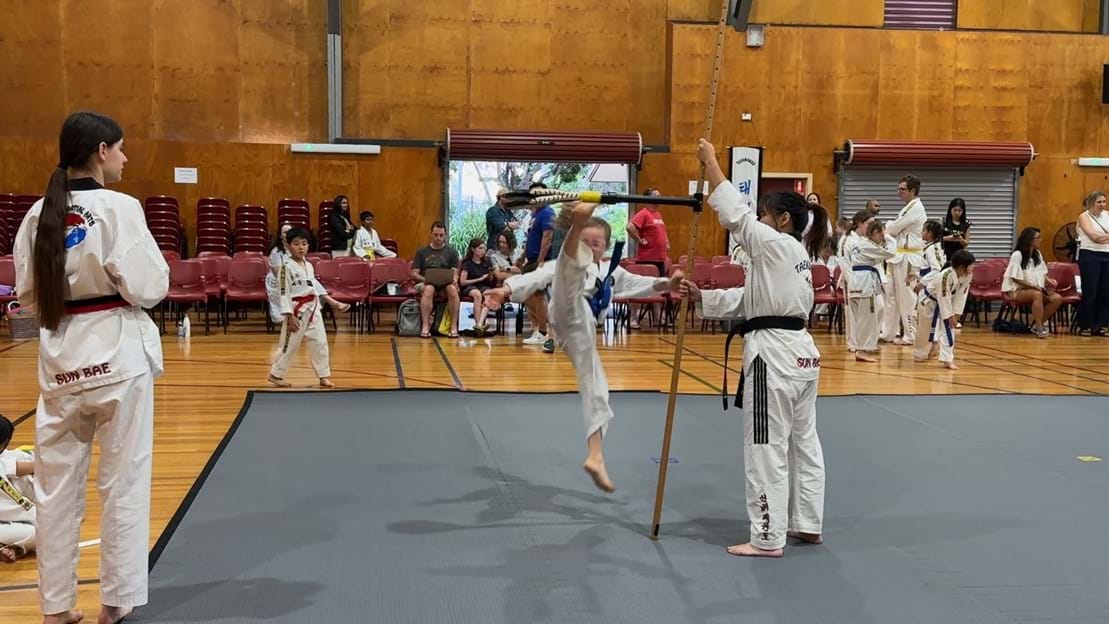 Taekwondo action - Sun Bae Korean Martial Art - Taekwondo Championship - Patterns, High Kick, Power Breaking, Roof Tiles, Kukkiwon, WT - World Taekwondo, Australia, Brisbane, Centres locations at Kenmore, Newmarket, The Gap, Middle Park, Mt Gravatt, Toowoomba, Grandmaster Bradley Tatnell. competition, white belt, yellow belt, blue belt, red belt, black belt, children, adults, male, female.