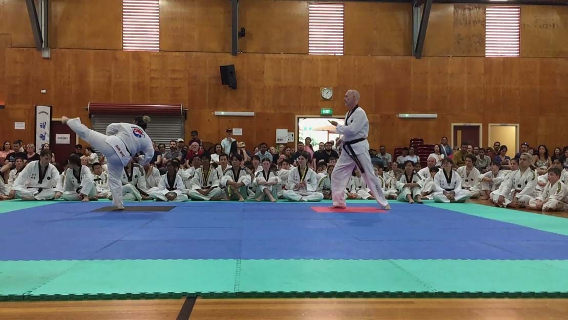 Taekwondo action - Sun Bae Korean Martial Art - Taekwondo Championship - Patterns, High Kick, Power Breaking, Roof Tiles, Kukkiwon, WT - World Taekwondo, Australia, Brisbane, Centres locations at Kenmore, Newmarket, The Gap, Middle Park, Mt Gravatt, Toowoomba, Grandmaster Bradley Tatnell. competition, white belt, yellow belt, blue belt, red belt, black belt, children, adults, male, female.