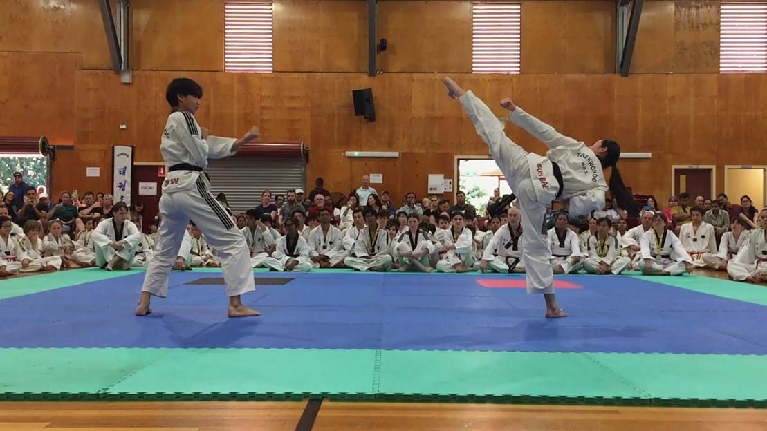 Taekwondo action - Sun Bae Korean Martial Art - Taekwondo Championship - Patterns, High Kick, Power Breaking, Roof Tiles, Kukkiwon, WT - World Taekwondo, Australia, Brisbane, Centres locations at Kenmore, Newmarket, The Gap, Middle Park, Mt Gravatt, Toowoomba, Grandmaster Bradley Tatnell. competition, white belt, yellow belt, blue belt, red belt, black belt, children, adults, male, female.