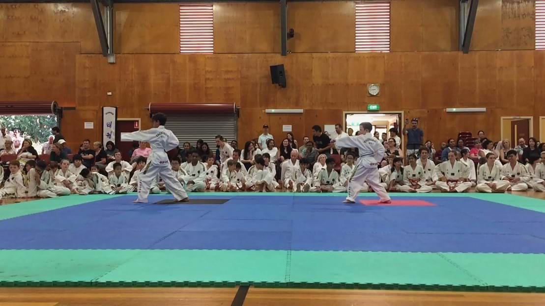 Taekwondo action - Sun Bae Korean Martial Art - Taekwondo Championship - Patterns, High Kick, Power Breaking, Roof Tiles, Kukkiwon, WT - World Taekwondo, Australia, Brisbane, Centres locations at Kenmore, Newmarket, The Gap, Middle Park, Mt Gravatt, Toowoomba, Grandmaster Bradley Tatnell. competition, white belt, yellow belt, blue belt, red belt, black belt, children, adults, male, female.