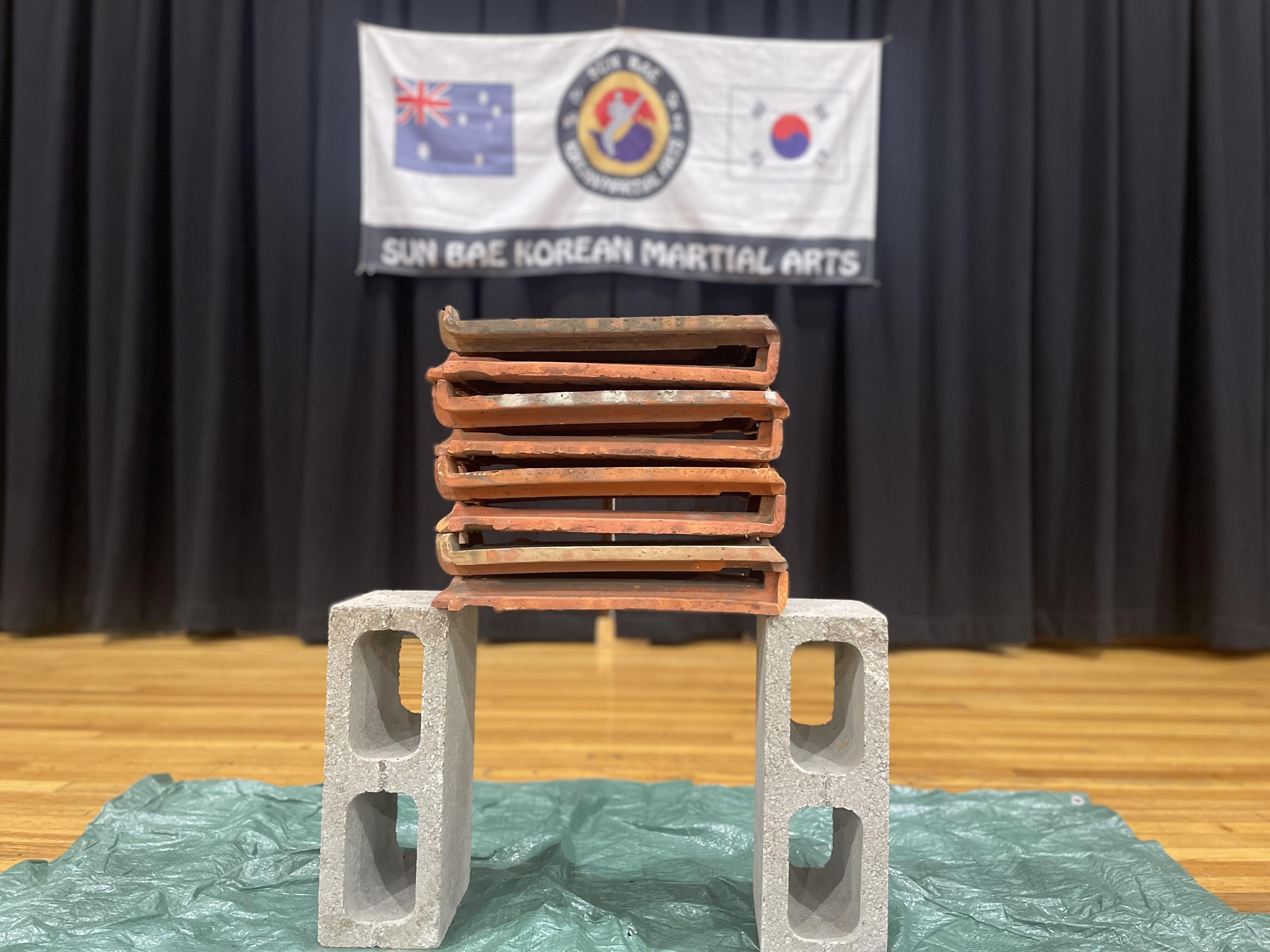 Tile breaking: Sun Bae Korean Martial Art - Taekwondo Championship - Patterns, High Kick, Power Breaking, Roof Tiles, Kukkiwon, WT - World Taekwondo, Australia, Brisbane, Centres locations at Kenmore, Newmarket, The Gap, Middle Park, Mt Gravatt, Toowoomba, Grandmaster Bradley Tatnell. competition, white belt, yellow belt, blue belt, red belt, black belt, children, adults, male, female.